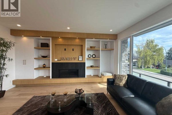 Living area with expansive windows overlooking a city view and wood flooring. - 1924 10 Avenue Nw, Calgary