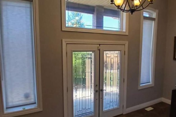 Front entrance with double glass doors, tall windows, and overhead transom window. - 1926 Mark Avenue, Windsor