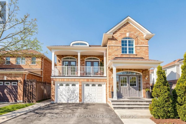 Front view of a large brick house with a covered porch and a second-floor balcony. - 193 Queen Mary Drive, Brampton