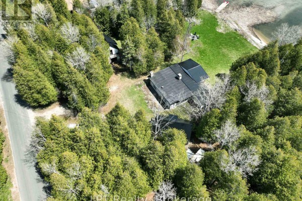 Aerial view of the property boundary line outlined in red, showing the house and waterfront. - 193 Tamarac Road, Northern Bruce Peninsula