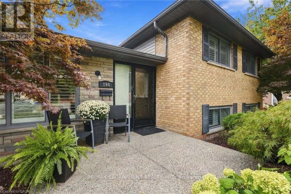 Front entrance walkway and porch with chairs and potted plants leading to the house. - 194 Foxbar Road, Burlington