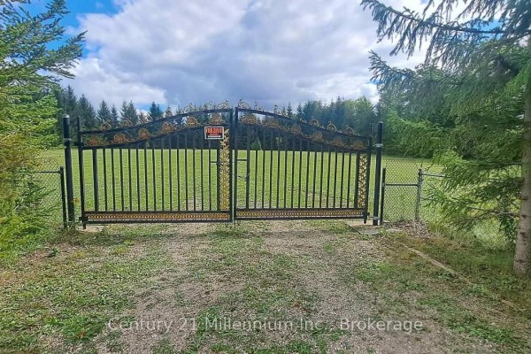 Ornate black metal gates with gold accents and a 'For Sale' sign. - 194247 Grey Road 13, Grey Highlands