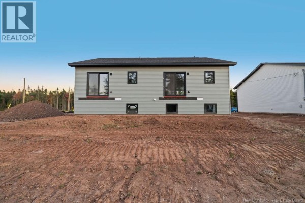 Rear view of a duplex showing multiple windows and two sliding glass doors on the main level. - 195 Carrington Drive, Riverview