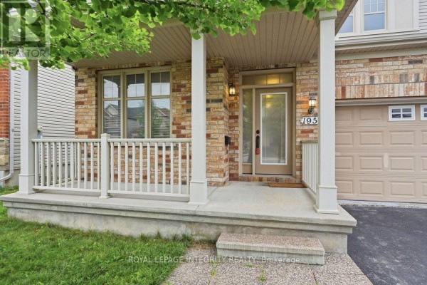 Living room with hardwood floors, fireplace, and large windows. - 195 Keyrock Drive, Ottawa