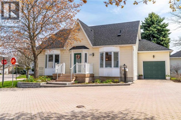 Front exterior view of a light yellow vinyl-sided house with a single-car garage and brick driveway. - 195 Silverbirch Boulevard, Glanbrook