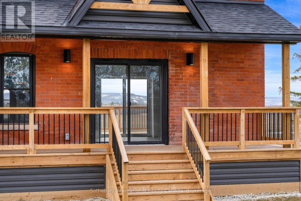 Brick house with wooden deck and stairs - 1952 Nottawasaga N Clearview