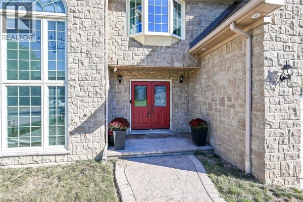 Close-up of the double red front doors with decorative glass panels. - 196 Bluebell Crescent, Ancaster