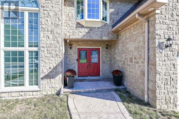 Close-up of the red front doors and stone exterior of the house. - 196 Bluebell Crescent, Hamilton