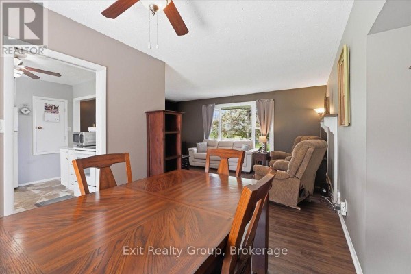 View from dining room into living room with fireplace and sofa. - 196 Elmwood Drive, Belleville