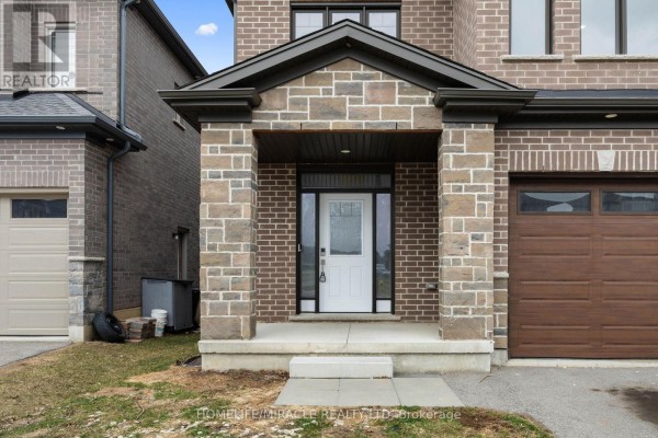 Close-up of the front entrance with stone details and porch steps - 196 Freure Drive, Cambridge