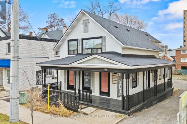 Close-up of the covered front porch with a white door and a light fixture. - 196 King Street, St  Catharines