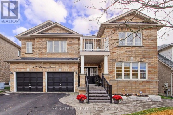 Two-story brick house with a double garage, covered porch, balcony, and large windows. - 196 Wainscot Avenue, Newmarket