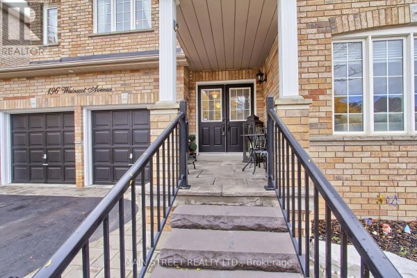 Front entrance with a covered porch, stone steps, black railings, and double doors. - 196 Wainscot Avenue, Newmarket