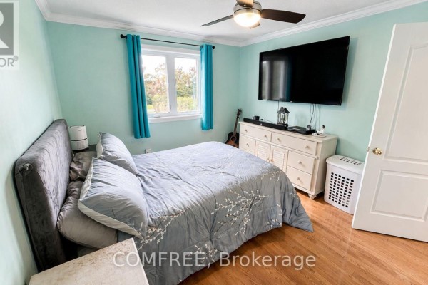 Bedroom with queen bed, dresser, TV, and window - 1960 Rolling Brook Drive Ottawa