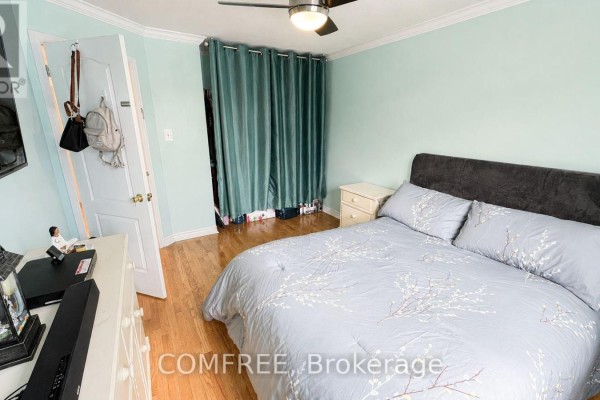 Bedroom with bed, dresser, TV, and teal closet curtain - 1960 Rolling Brook Drive Ottawa