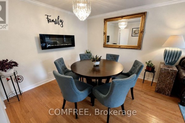Living room and dining room connected by an open doorway, showcasing furniture and decor.  - 1960 Rolling Brook Drive, Ottawa