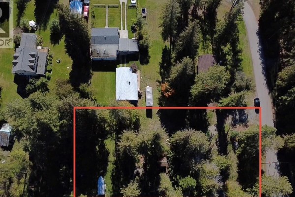 Aerial view of a property with trees, a small building, and a boat, bordered by a red line. - 1962 Tambellini Road, Christina Lake
