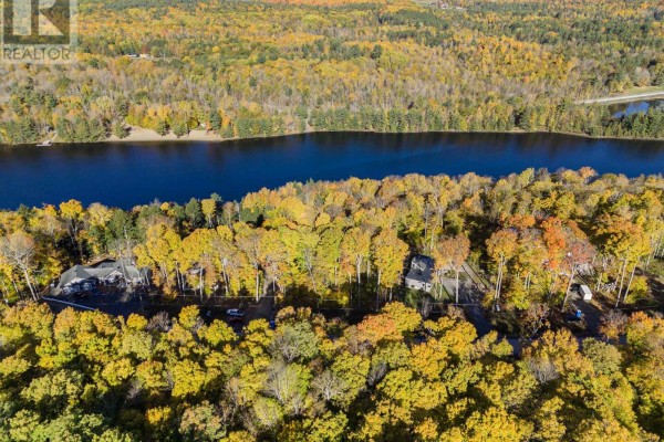 Aerial view of a wooded landscape with multiple houses and a winding road. - 197 Shady Maple Road, Mcnab/braeside