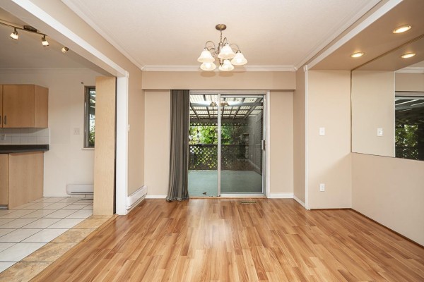 View of the spacious backyard with a lawn, trees, a garden shed, and fencing. - 19751 54a Avenue, Langley
