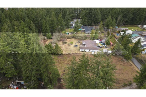 Aerial view showcasing the property with surrounding trees and nearby structures. - 19840 30 Avenue, Langley