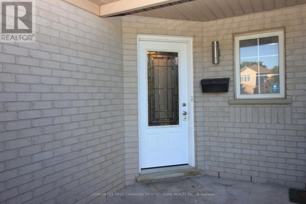 Close-up view of the front entrance of a house with a white door and brick walls. - 199 Emerald Road, London South