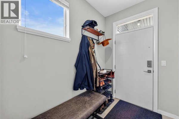 Entryway with a bench, shoe rack, and white front door. - 1993 Qu'appelle Boulevard Unit# 120, Kamloops