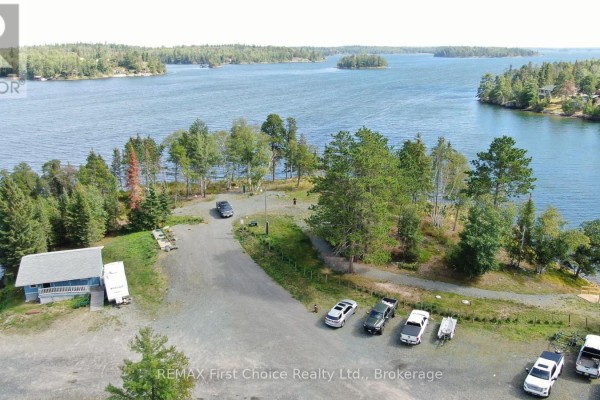 View of the frozen lake from the property, with trees in the foreground - 19a Miller Road, Sioux Narrows Nestor Falls