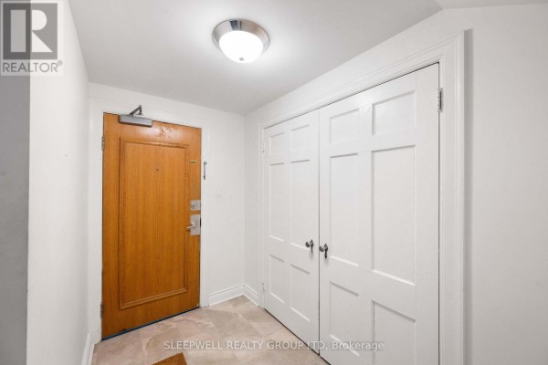 Dining area with white table, four chairs, and glass-front cabinet. - 1a - 180 Augusta Street, Ottawa