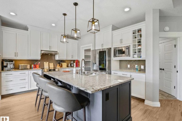 Modern kitchen with white cabinets, granite countertops, stainless steel appliances, and an island. - 1a 53521 Rge Rd 272, Rural Parkland County