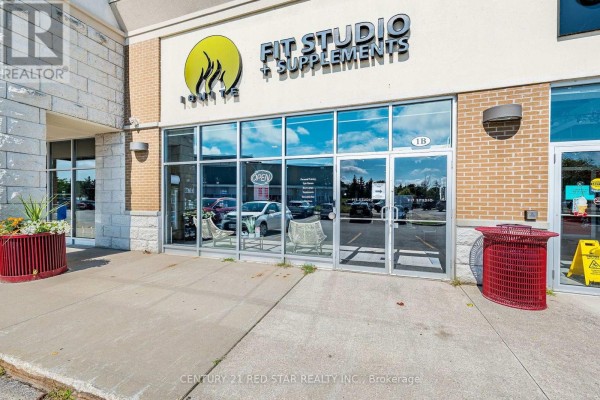 Exterior view of Fit Studio & Supplements with large glass entrance and signage - 1b - 1 Market Lane, Wasaga Beach