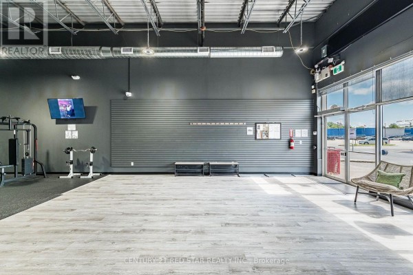 Gym section with multi-use equipment, free weights, and colorful exercise balls - 1b - 1 Market Lane, Wasaga Beach