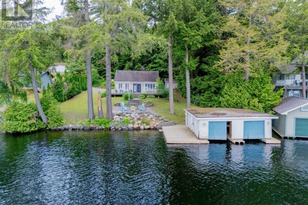 Aerial view of a cottage deck, patio, and boathouse by the lake. - 2 - 1018 Georgina Way, Gravenhurst)