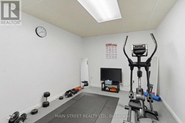 Home gym with elliptical machine, dumbbells, and exercise mat - 2 - 110 Silvan Drive, Welland