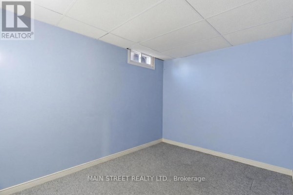 Finished basement room with drop ceiling and carpet flooring - 2 - 110 Silvan Drive, Welland