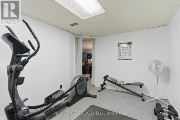 Basement gym with elliptical, weight bench, dumbbells, drop ceiling - 2 - 110 Silvan Drive, Welland