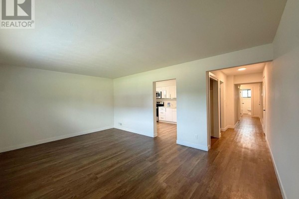 Empty room with white walls, wood-look flooring, and a single window with blinds. - 2 - 171 Huron Street, Guelph