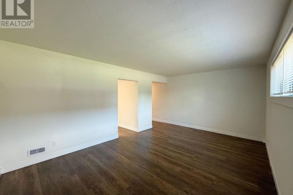 View of an empty room showing white walls, wood-look flooring, and an open closet. - 2 - 171 Huron Street, Guelph