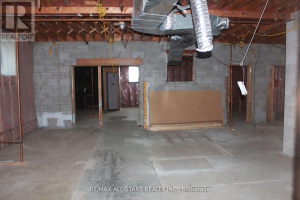 Large unfinished commercial space with cinder block walls, exposed ceiling, and ductwork. - 2 - 183 Simcoe Avenue, Georgina