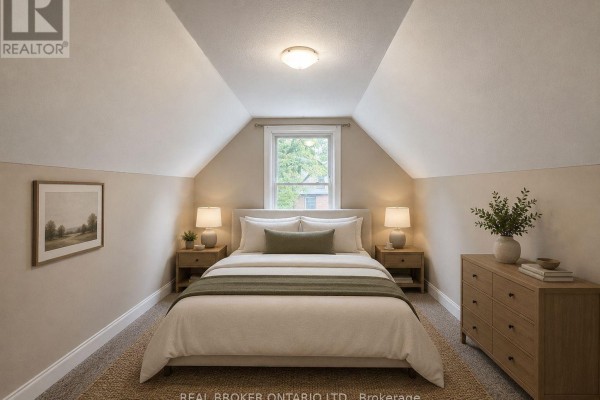 Bedroom with vaulted ceiling, king-size bed, two nightstands, dresser, and a window. - 2 - 189 Stinson Street, Hamilton
