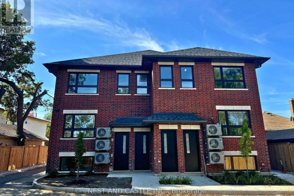 Rear exterior of a brick duplex with multiple air conditioning units visible. - 2 - 20 West Street, Brampton
