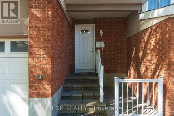 Close-up of the townhouse front entrance with brick siding and stairs. - 2 - 2669 Southvale Crescent E, Ottawa
