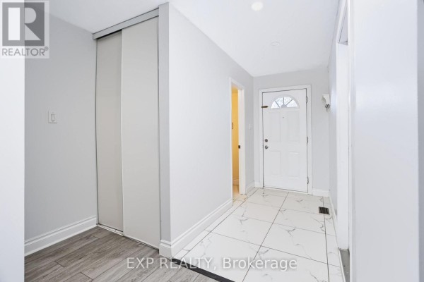 Interior hallway with light grey walls and large white sliding closet doors. - 2 - 2669 Southvale Crescent E, Ottawa