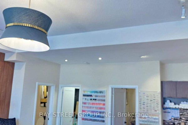 Interior view of a salon with a decorative pendant light and doorways. - 2 - 2671 Bur Oak Avenue, Markham