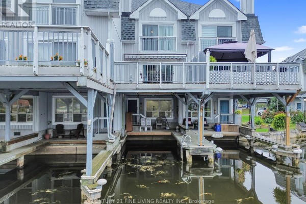 Rear view of townhouses with boat docks and water access. - 2 - 30 Laguna Parkway, Ramara