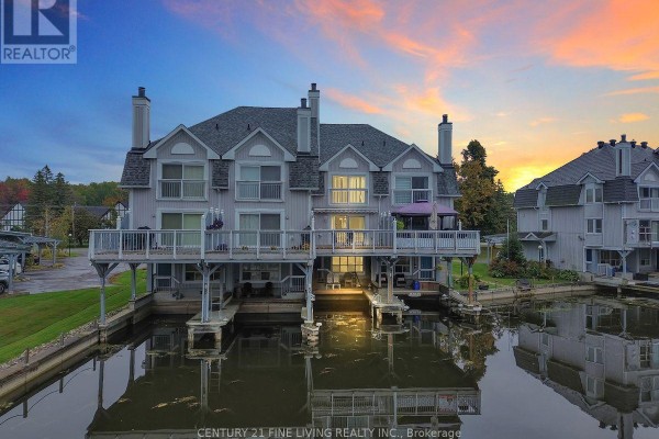 Townhouse complex on the water with docks and balconies. - 2 - 30 Laguna Parkway, Ramara