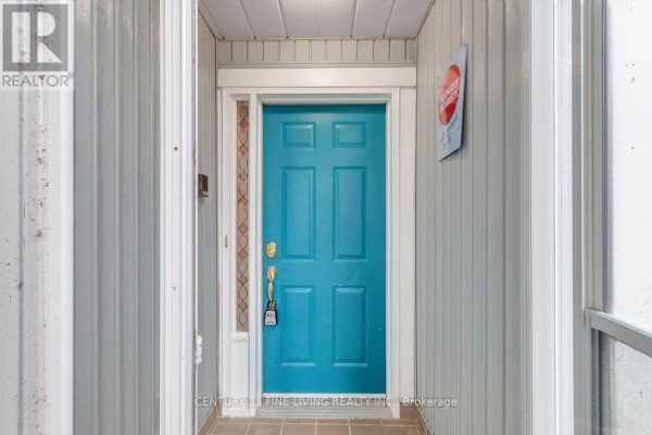Close-up of a bright blue front door on a townhouse. - 2 - 30 Laguna Parkway, Ramara