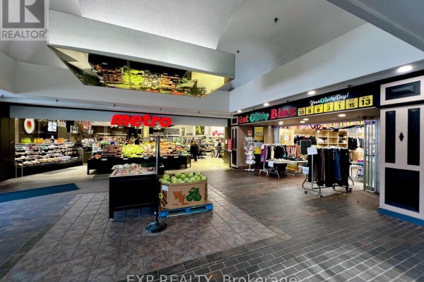 Interior view of a mall concourse with a Metro grocery store on the left and a retail store on the right. - 2 - 301 Oxford Street W, London North