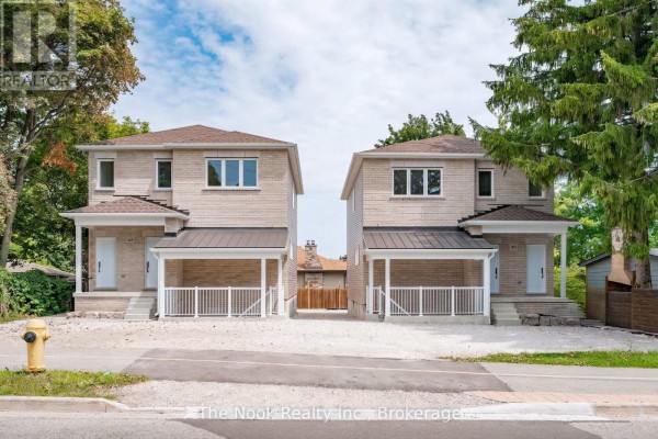 Front exterior view of two identical beige brick multi-family homes with covered porches, facing the street. - 1 - 399 Thorton Road N, Oshawa