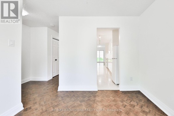 Interior view showing parquet flooring and an open doorway to the kitchen. - 2 - 4635 Regents Terrace, Mississauga