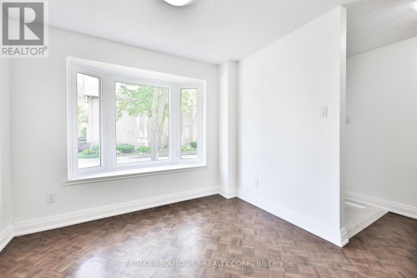 Room with a large bay window, parquet flooring, and white walls. - 2 - 4635 Regents Terrace, Mississauga